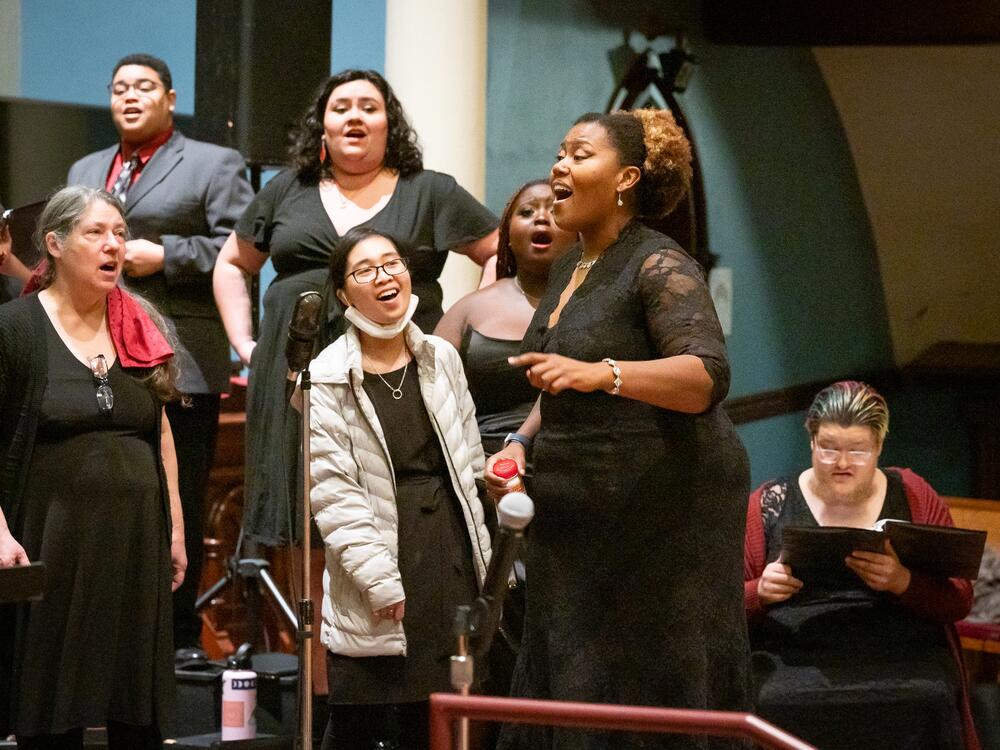 Coty Raven Morris conducts the combined Rose and Thorn Choirs singing an African piece called 