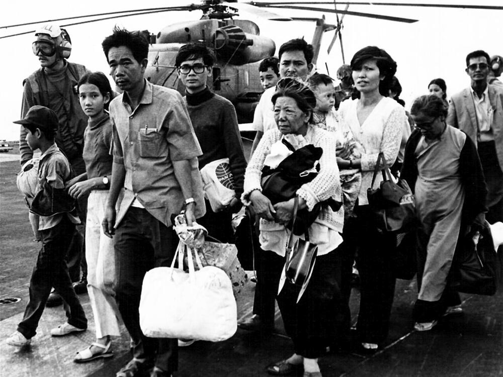 Vietnamese refugees evacuated by helicopter arrive on board the USS Midway ahead of the fall of Saigon on April 29, 1975.