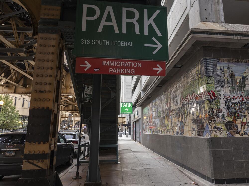 Signs direct traffic to the immigration court parking lot in Chicago, Ill., in August 2024.