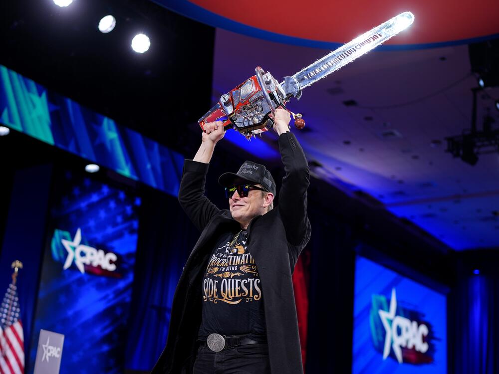 Elon Musk wields a chainsaw at the Conservative Political Action Conference on Feb. 20 in Oxon Hill, Md.