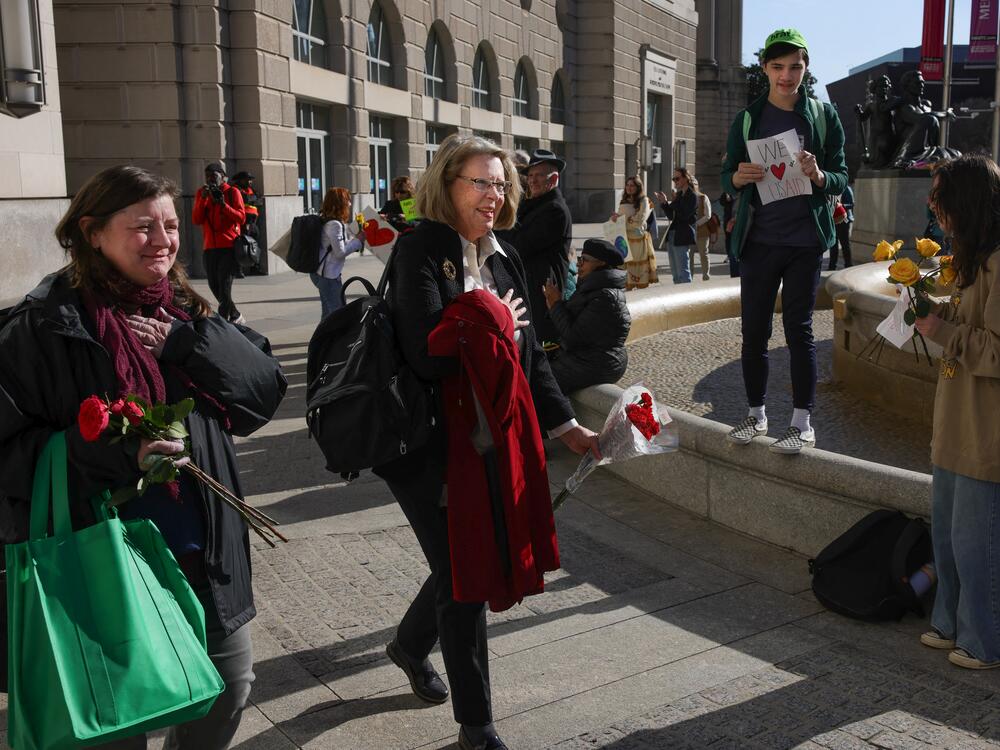 A terminated federal worker leaves the offices of the U.S. Agency for International Development in Washington, D.C., on Feb. 28 after being laid off following Trump's order to cut funding to the agency. That decision that was driven by DOGE's work.