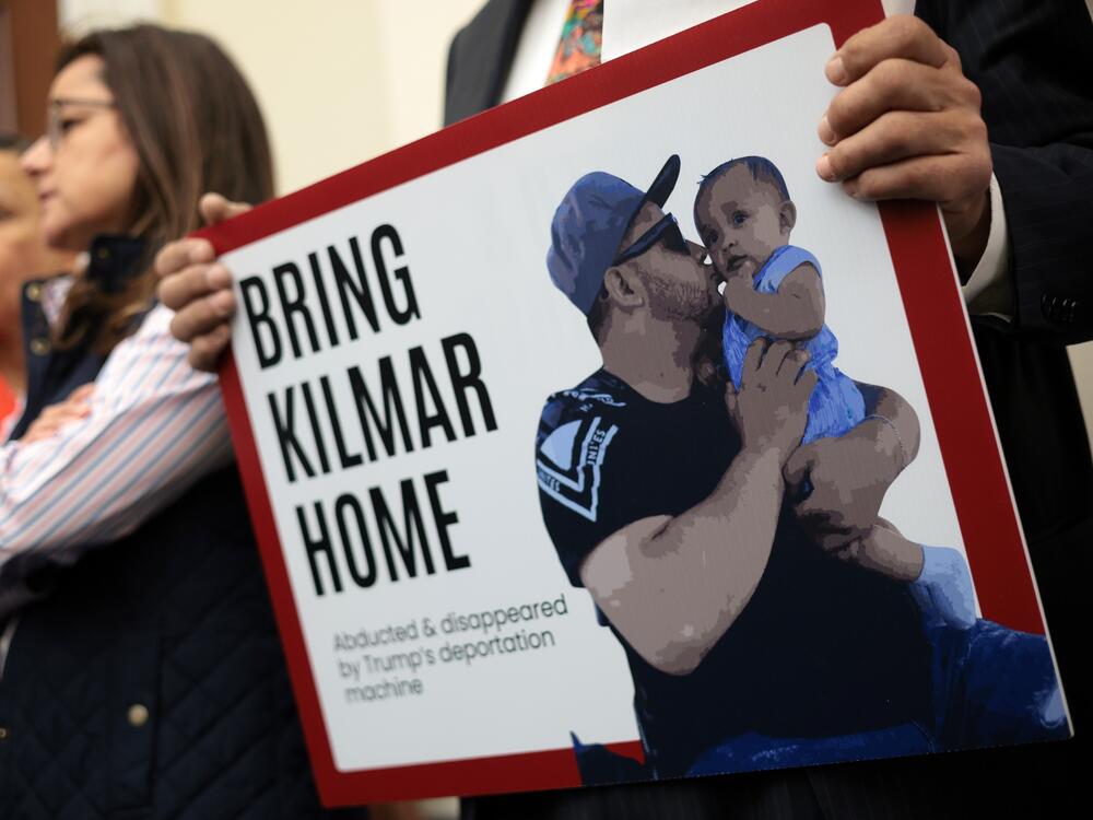 A member of the Congressional Hispanic Caucus holds a picture of Kilmar Abrego Garcia during a news conference on April 9, 2025.
