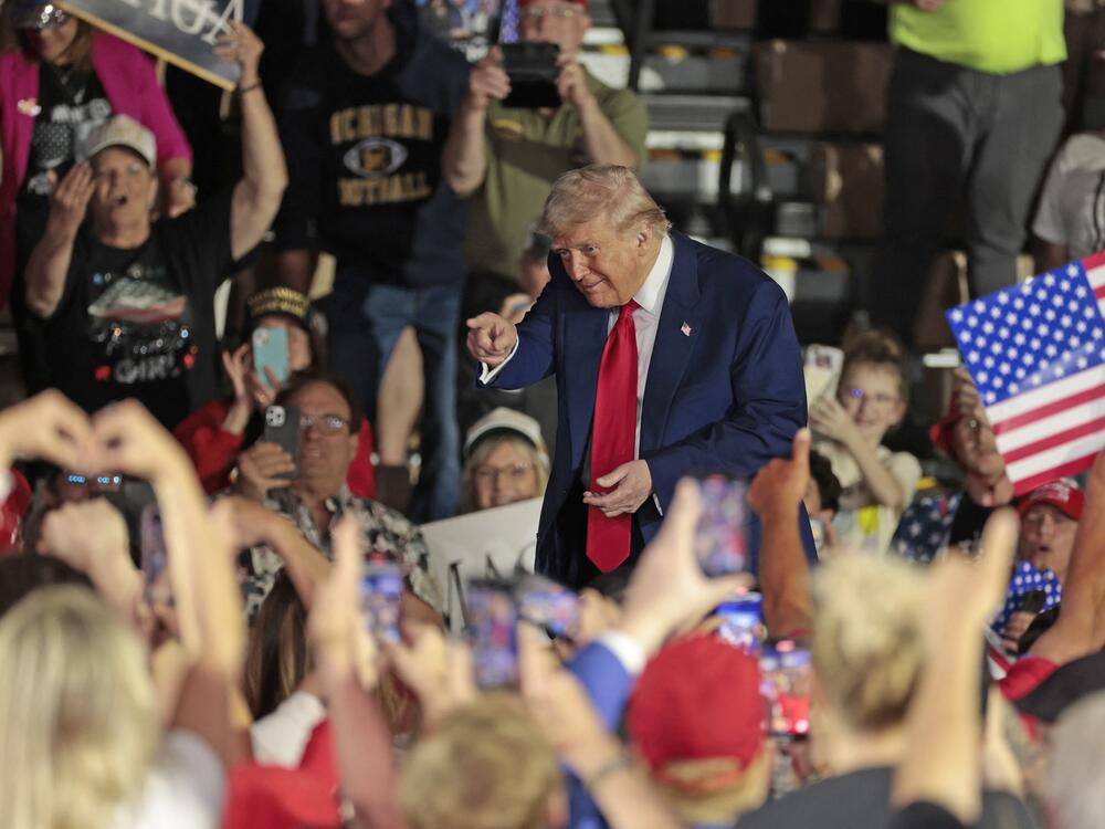 Trump gestures to the crowd at the at the end of his address marking 100 days in office.
