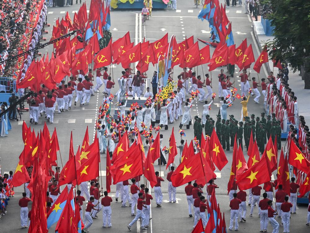 Participants perform during a parade marking the 50th anniversary of the fall of Saigon and the end of the Vietnam War in Ho Chi Minh City on April 30, 2025.