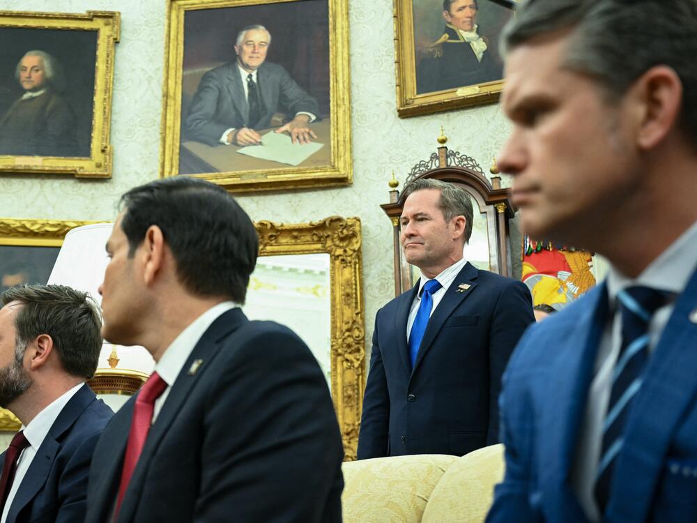 National security adviser Mike Waltz stands behind Vice President Vance, Secretary of State Marco Rubio and Secretary of Defense Pete Hegseth in the Oval Office on April 7, 2025.