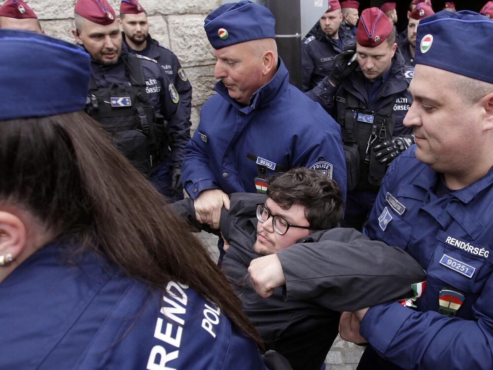 Hungarian police remove a protester blocking the entrance of the Parliament building in Budapest on April 14, as Hungarian lawmakers were expected to approve constitutional changes further clamping down on rights for certain groups, part of Prime Minister Viktor Orbán's 