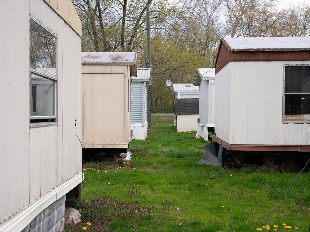 In Rising Sun, trailers that were damaged by floodwaters years ago sit empty. Many people have left the neighborhood. Others stay, despite the risk of a future flood that could trap them in their homes.