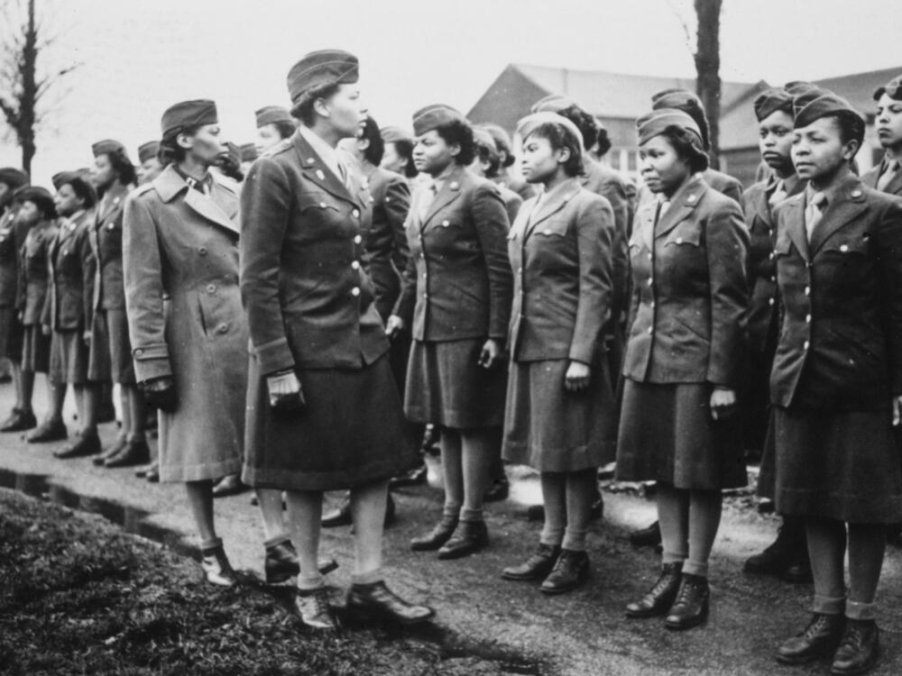 American Women's Army Corps (WAC) Captain Mary Kearney and American WAC Commanding Officer Major Charity Adams inspect the first arrivals to the 6888th Central Postal Directory Battalion at a temporary post in Birmingham, West Midlands, England, in February 1945.