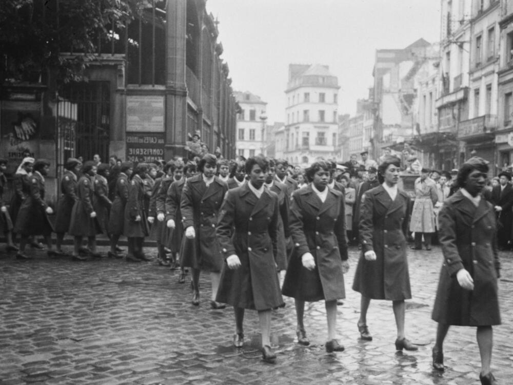 Military personnel of the 6888th Central Postal Directory Battalion take part in a parade in honor of Joan d'Arc in Rouen, France, 1945.