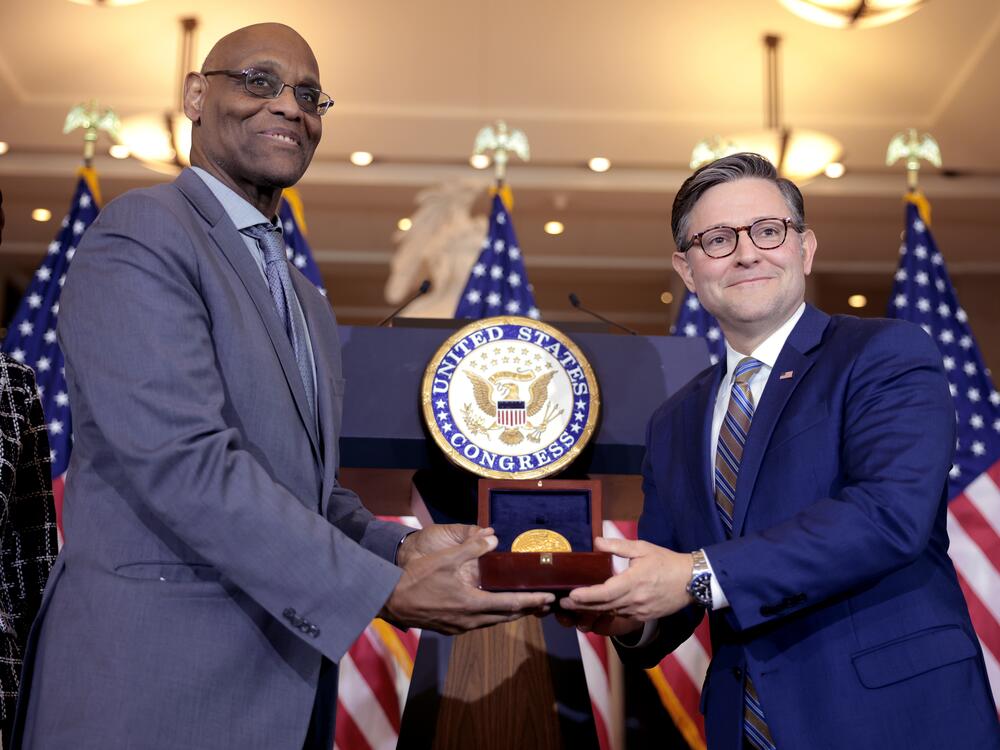 House Speaker Mike Johnson (right) presents the Congressional Gold Medal for the 6888th Central Postal Directory Battalion to Stanley Earley III, the son of battalion commander Maj. Charity Adams, during a ceremony in Emancipation Hall on Tuesday in Washington, D.C.