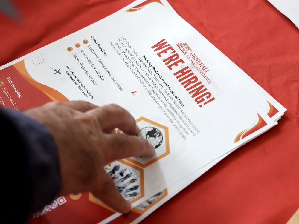 A 'we're hiring' pamphlet at the Mega JobNewsUSA South Florida Job Fair at the Amerant Bank Arena in Sunrise, Fl., on April 30, 2025. Employers continued to add jobs in April, even as Trump's trade war took a toll on economic growth.