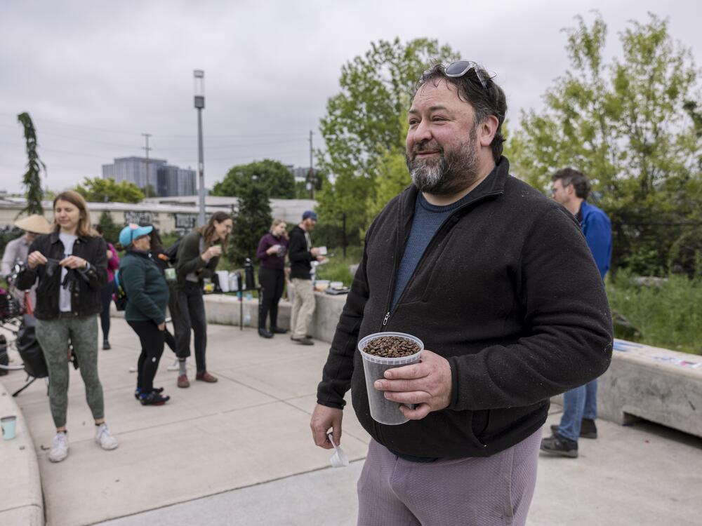 Andrew Kreps, one of the organizers for the Blumenauer Bridge breakfast, holds coffee beans he roasted himself.