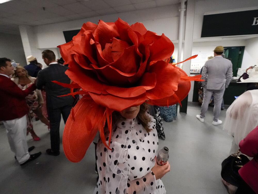 Brittany McKewn, of Asheville, N.C., wears a hat shaped like a rose before the 148th running of the Kentucky Derby horse race at Churchill Downs on May 7, 2022, in Louisville, Ky.