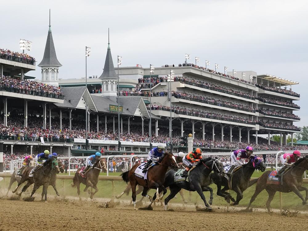 Javier Castellano, atop Mage (fourth from left), is seen behind with others behind the pack as they make the first turn while competing in the 149th running of the Kentucky Derby on May 6, 2023.