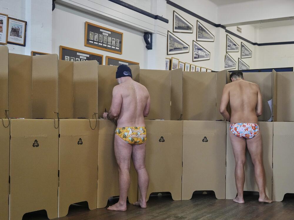 People vote at a polling booth at Sydney's Bondi Beach, Saturday, May 3, 2025.