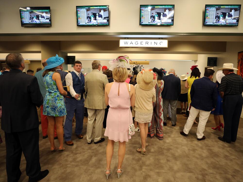 Fans wait in line at the wagering window prior to the 145th running of the Kentucky Derby at Churchill Downs on May 4, 2019.