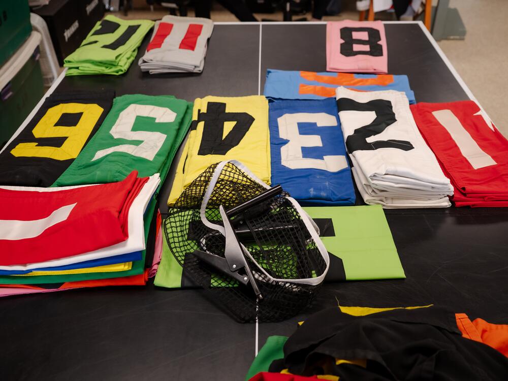 Program numbers, found on each race horses' saddlecloth, are laid out on a table in the jockey quarters of Churchill Downs in Louisville, Ky., on April 30, 2025.