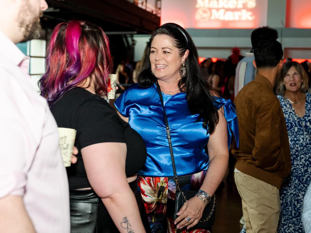 Mindy Coleman talks with invited guests at Jocktails, a charity bartending event that supports the Permanently Disabled Jockeys Fund, on April 30, 2025.