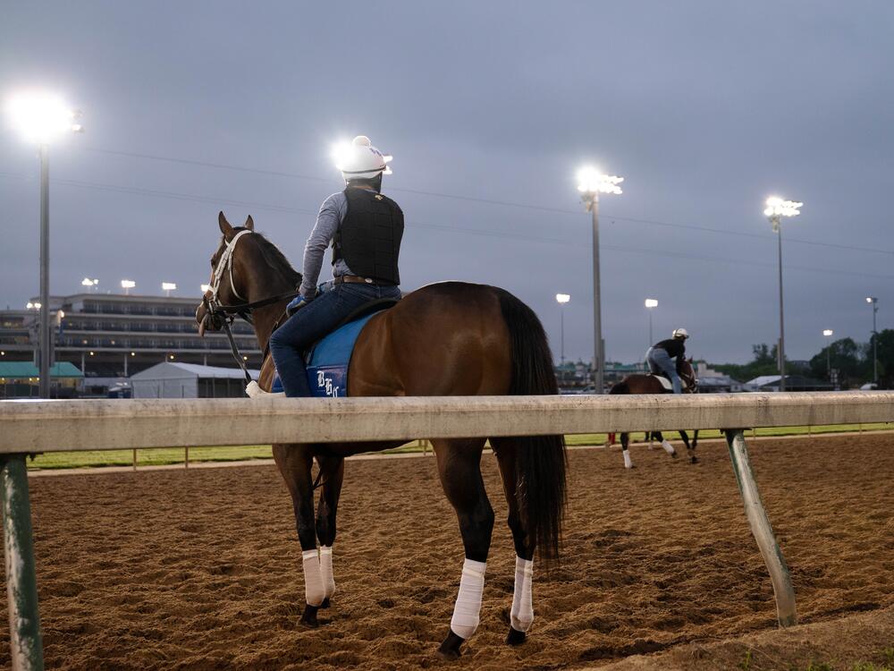 A jockey trains before sunrise on a horseracing track in Louisville, Ky., on April 30, 2025.