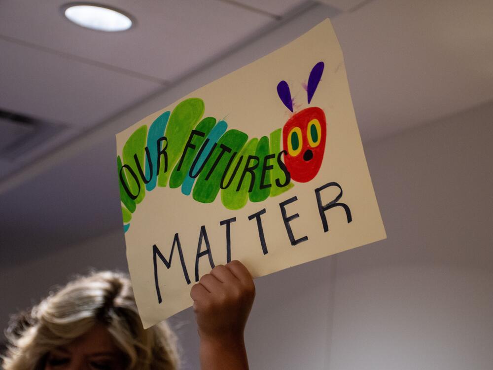 A protester holds up a sign to demonstrate against a bill in Tennessee that would have allowed public schools to prevent students without legal status from attending.