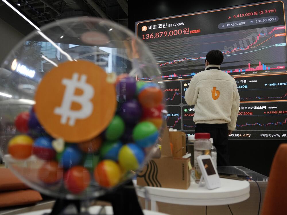 FILE - An employee watches an electronic signboard displaying the prices of Bitcoin and other cryptocurrencies at the lounge of Bithumb cryptocurrency exchange in Seoul, South Korea, Nov. 21, 2024.
