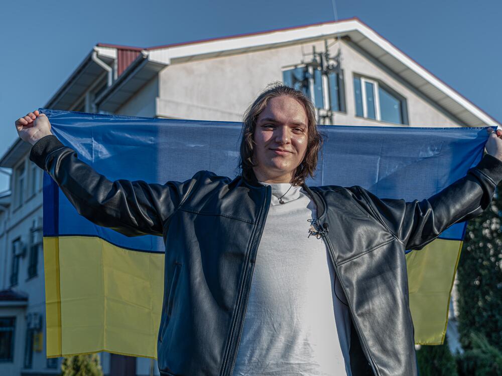 Ivan holds the Ukrainian flag after receiving his Ukrainian national ID card, in the Kyiv region.