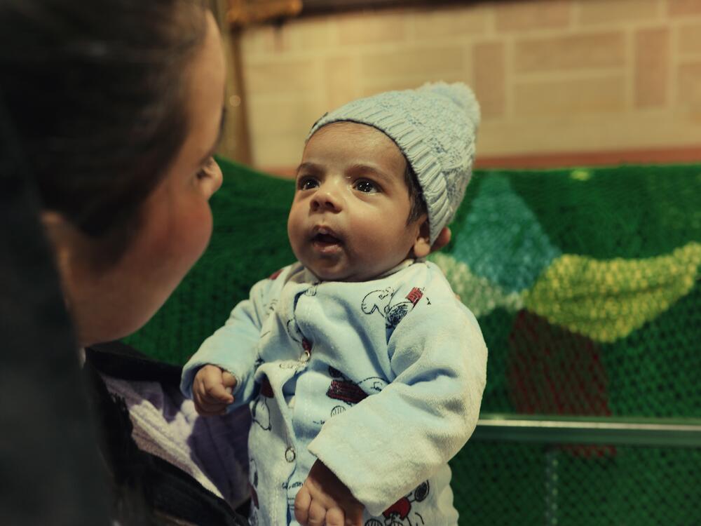 A Druze woman holds her baby daughter at the shrine.