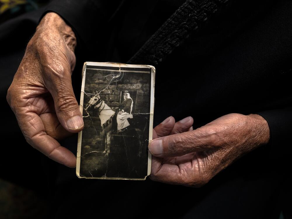 Nawaf Nasr, a 78-year-old member of Syria's Druze community, holds a creased black-and-white photo that he says shows him on horseback in a previous life before he died. The Druze religion holds that reincarnation is a path to spiritual purification.