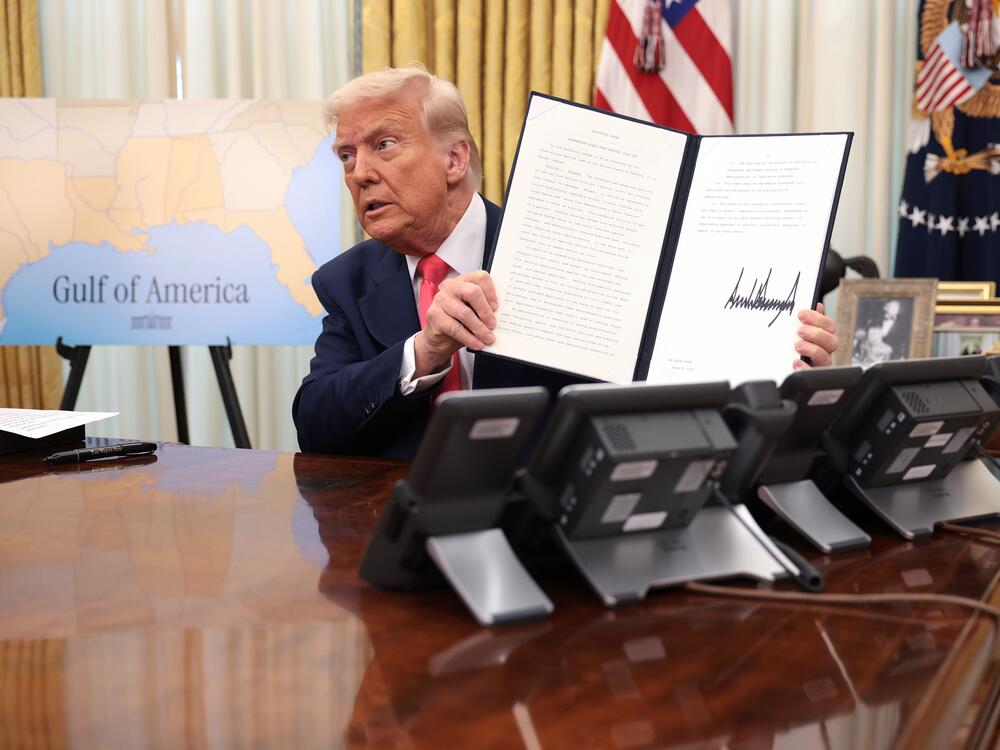 President Donald Trump signs executive orders in the Oval Office of the White House on March 6, including an order terminating the security clearances of those who work at the law firm Perkins Coie.