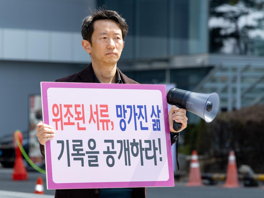 Jonggeun Song, born in 1979 and adopted in the Netherlands at age 4, stages a one-person protest in front of the Korea Child Rights Protection Agency in Seoul, South Korea, on April 1. He holds a sign that reads, ''Forged Documents, Broken Lives, Release the Records.'' He calls for the disclosure of overseas adoption records and an end to international adoptions.