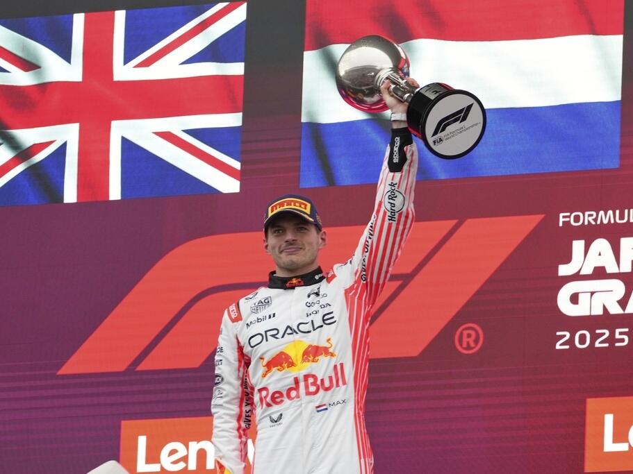 F1 driver Max Verstappen of the Netherlands raises his trophy after the Japanese Formula One Grand Prix on April 6, 2025.