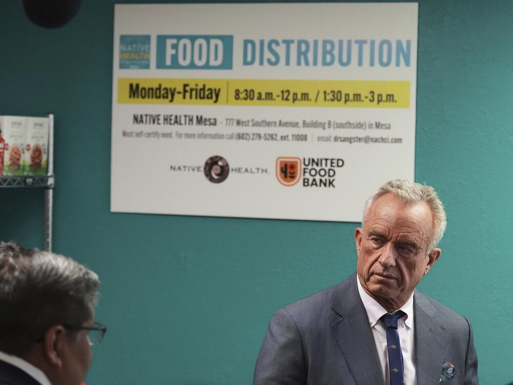 U.S. Health Secretary Robert F. Kennedy Jr. tours a food bank in Mesa, Ariz., on April 8, 2025. Arizona Gov. Katie Hobbs vetoed a law backed by Kennedy and FGA to keep SNAP benefits from being spent on soda.