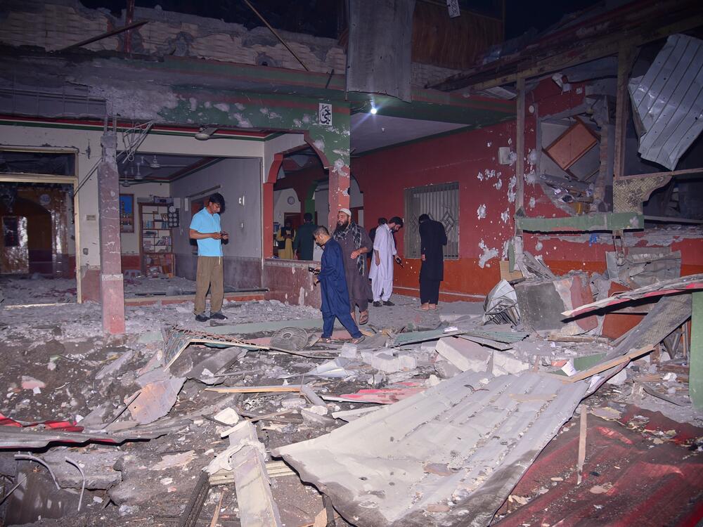 Local residents and members of the media examine a building damaged by a suspected Indian missile attack near Muzaffarabad, the capital of Pakistan-controlled Kashmir, on Wednesday.