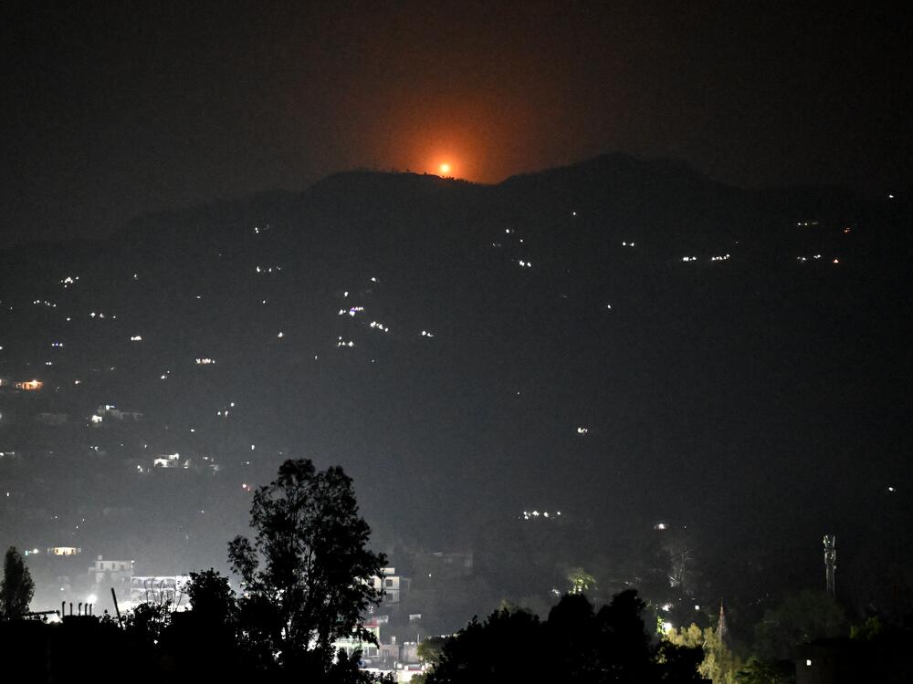 A flare rises in the air over the hill near the main town of Poonch district, India, on Wednesday. India said it carried out 