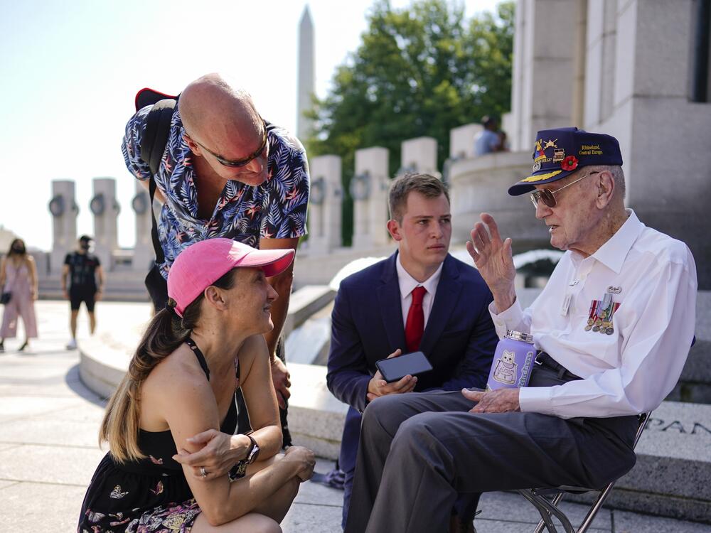 Harry Miller speaks to several people during a visit to the World War II Memorial in Washington, D.C. on Memorial Day in 2022.