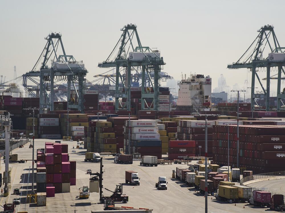 Trucks line up amid stacks of shipping containers at the Port of Los Angeles in Los Angeles, in early April.