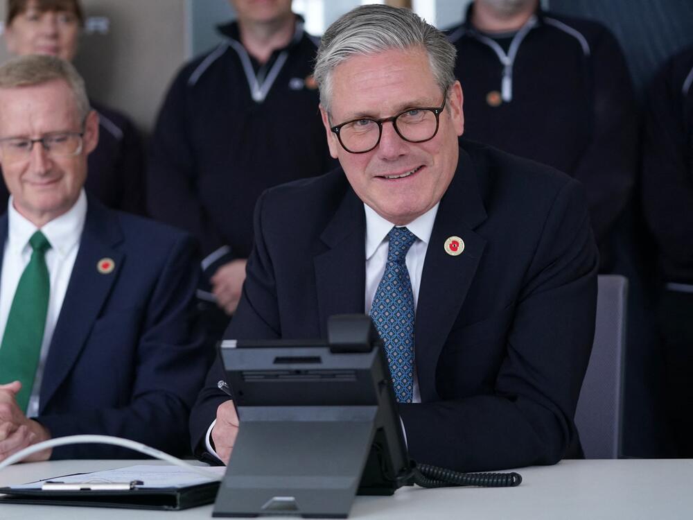 Britain's Prime Minister Keir Starmer smiles as he discusses a trade deal with President Trump over the phone on May 8, 2025.