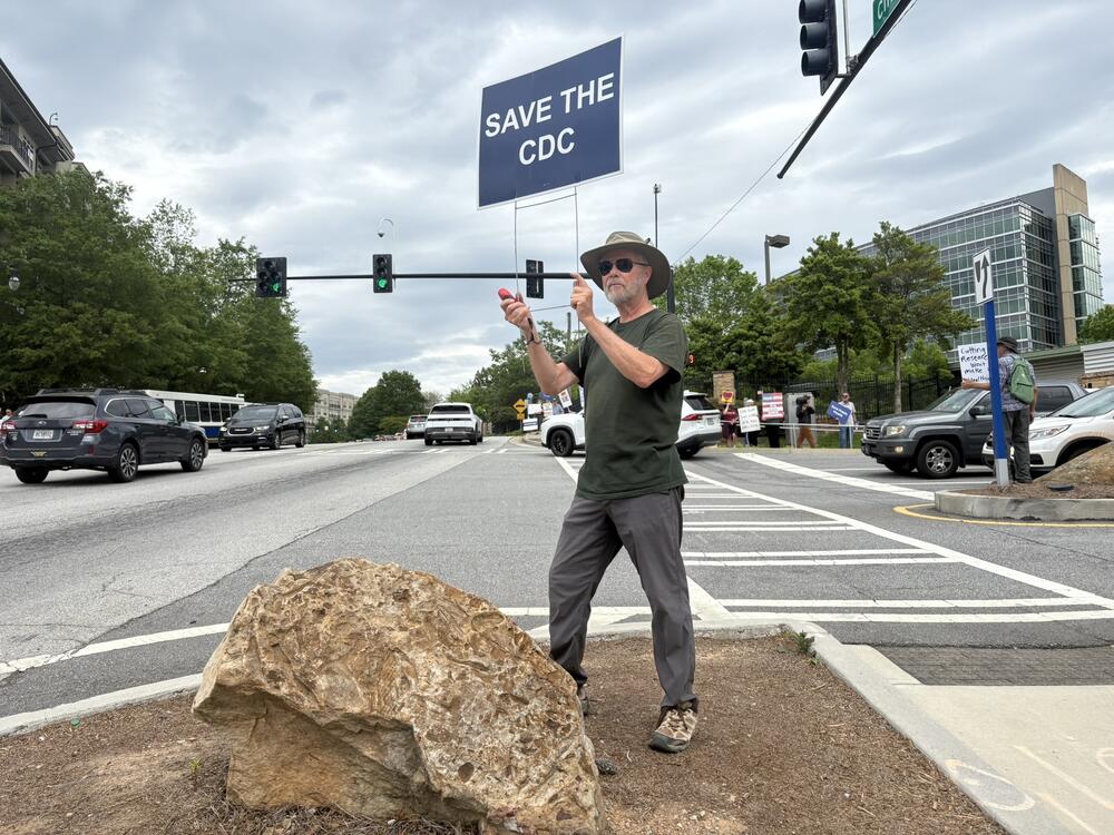 Michael Beach, former deputy director of the Division of Foodborne, Waterborne and Environmental Diseases at CDC, attends a weekly protest outside the agency's main campus in Atlanta.