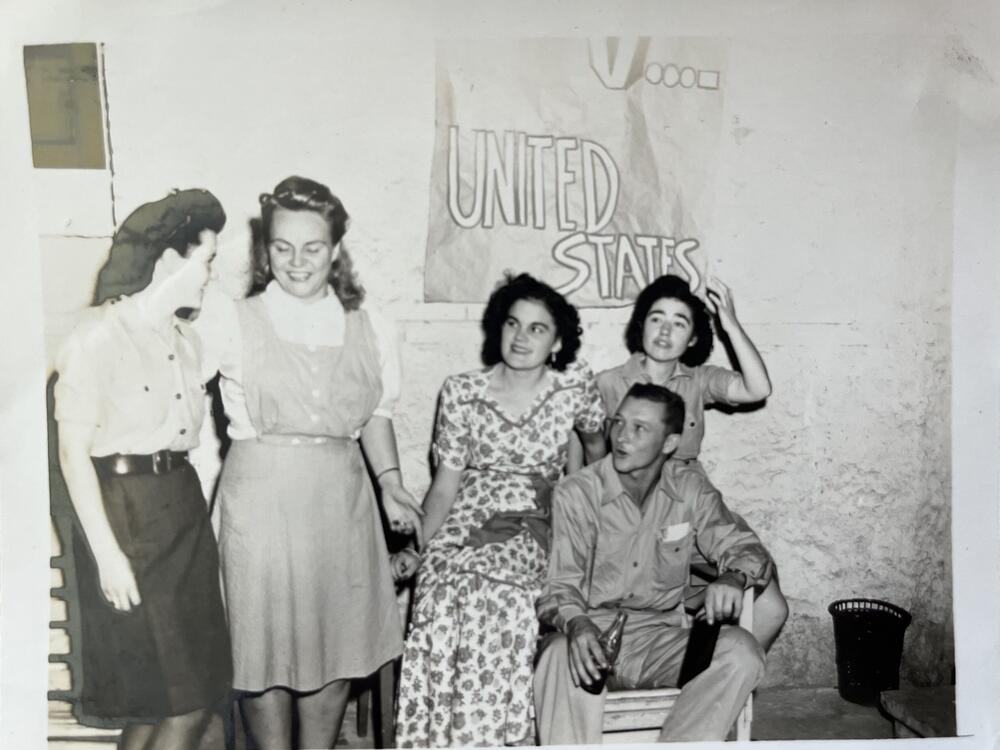 My mother (center in print dress) celebrating the Allied victory on May 5, 1945, the day Germany surrendered, ending the war in Europe.