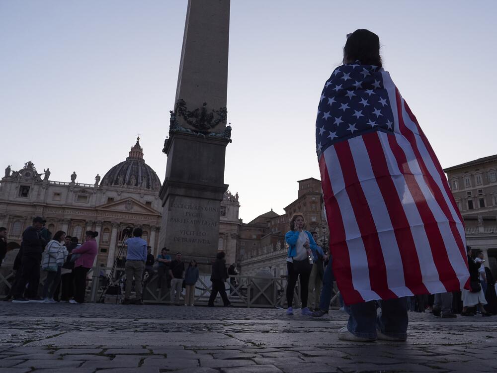 Andrea Gallardo, 20, from Texas, wears an American flag after Pope Leo XIV appeared on the balcony of St Peter's Basilica following his election, at the Vatican, Thursday, May 8.