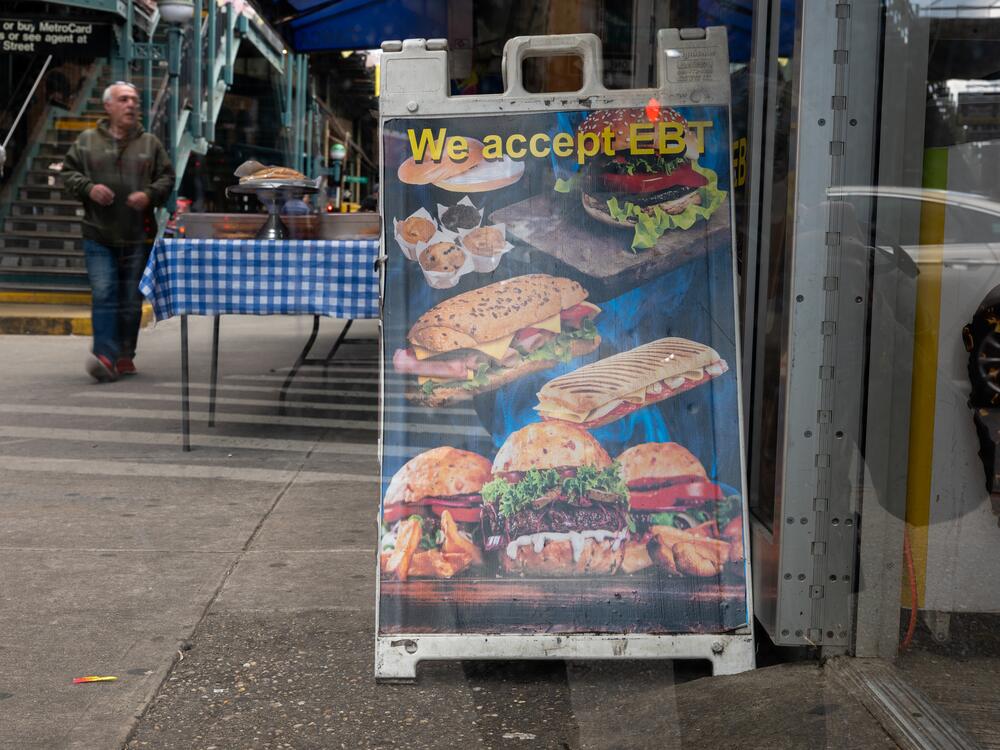 A sign outside of a grocery store welcomes those on food assistance in a  Brooklyn neighborhood that has a large immigrant and elderly population on Oct. 16, 2023 in New York City.