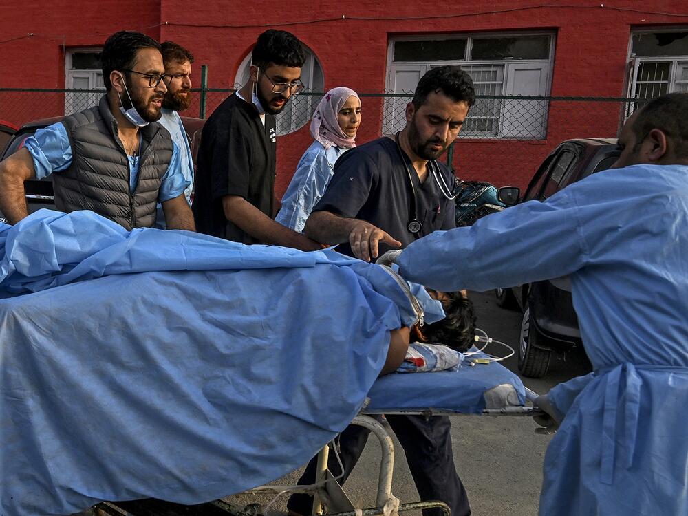 Paramedics carry an injured tourist at a hospital in Anantnag, south of Srinagar, on April 22, following an attack. Gunmen in Indian-administered Kashmir opened fire on a group of tourists in one of the worst attacks targeting civilians for years in the region.