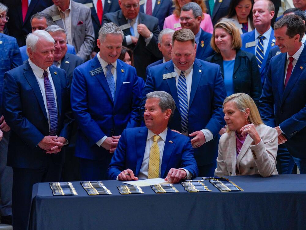 Georgia Republican Gov. Brian Kemp signs into law a series of education bills in April, including a measure preventing transgender girls from playing on girls' sports teams.