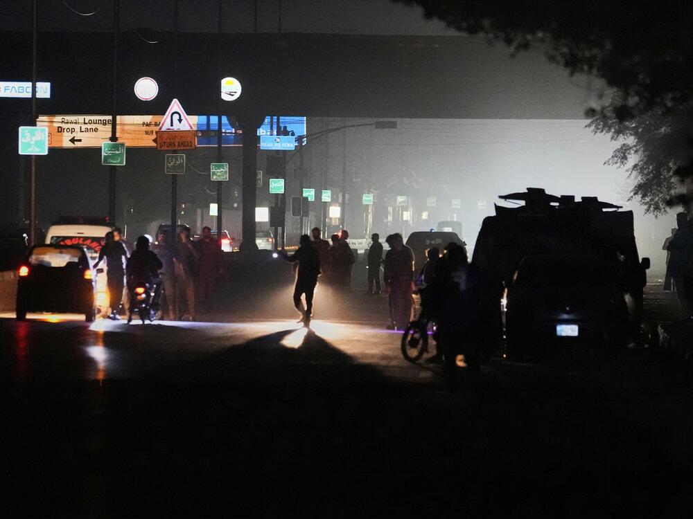 Pakistani police officers remove vehicles and people from the main entry of Nur Khan airbase following an Indian missile strike in Rawalpindi, Pakistan, on Saturday.