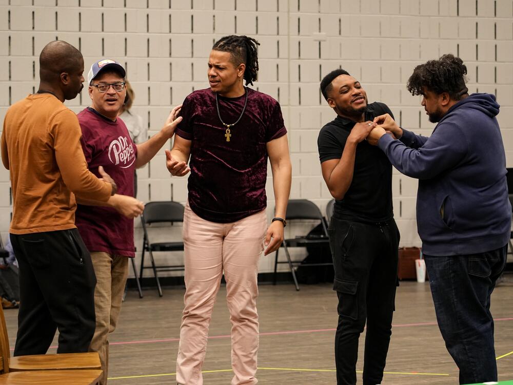 Justin Hopkins, left, Nathan Granner, David Morgans, Markel Reed and Chaz'men Williams-Ali rehearse a scene for Detroit Opera's performances of Anthony Davis' opera <em>The Central Park Five </em>on May 10, 16 and 18