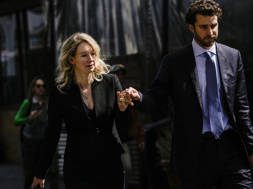 Former Theranos CEO Elizabeth Holmes and her partner, Billy Evans, following a hearing at the Robert E. Peckham U.S. Courthouse on March 17, 2023 in San Jose, California. Evans has raised millions of dollars for a new health tech startup that Holmes is advising him on.