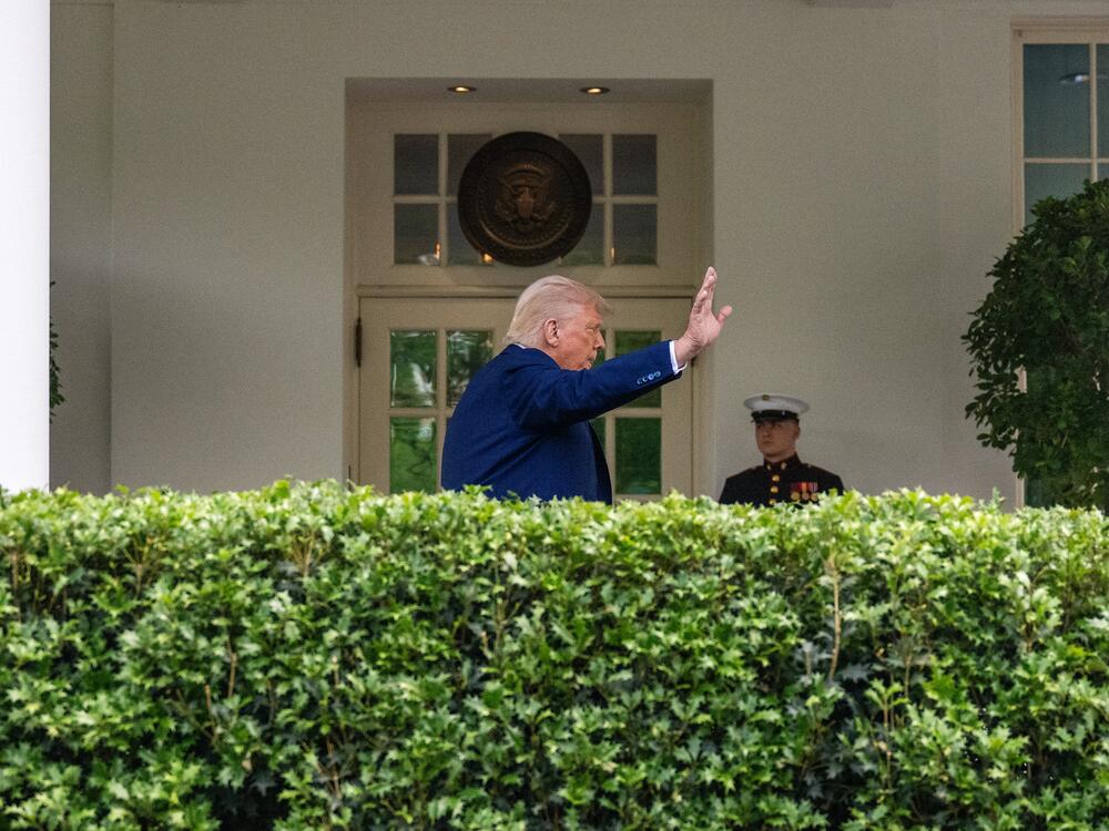 President Trump waves after taking questions from reporters outside the White House on May 8.