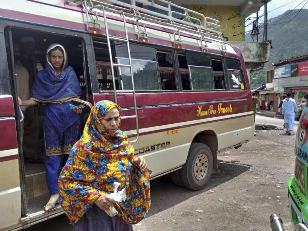 Local residents depart a passenger bus upon their arrival at a bus terminal, day after the ceasefire between Indian and Pakistan was announced, in Chakothi, near Line of Control, some 61 kilometres (38 miles) from Muzaffarabad, the capital of Pakistan controlled Kashmir, Sunday, May 11, 2025.