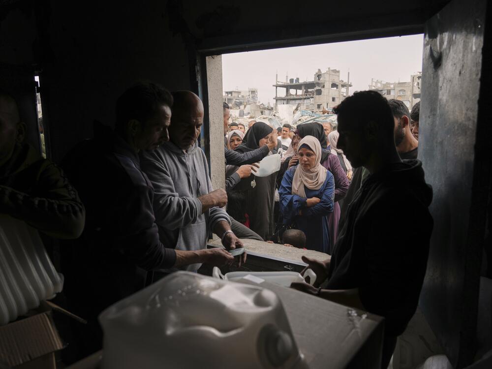 Palestinians receive humanitarian aid distributed by UNRWA, the U.N. agency helping Palestinian refugees in Jabaliya, Gaza Strip on Wednesday, April 9, 2025.
