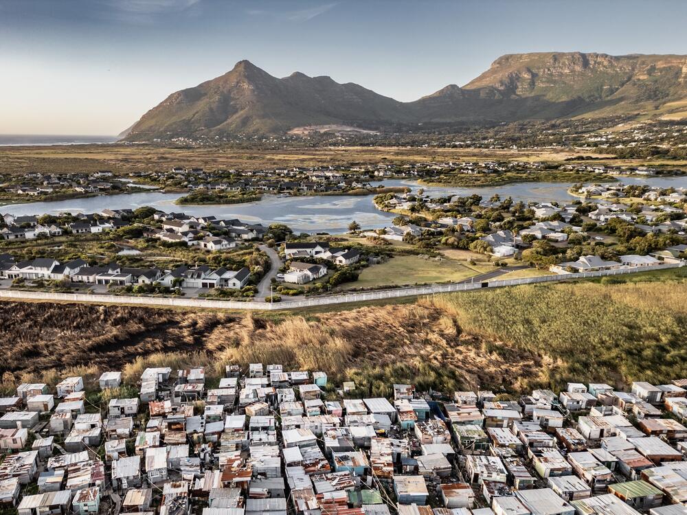 An aerial view of the township of Masiphumelele (foreground) and the Lake Michelle gated estate (rear), in Cape Town, South Africa. Thirty years after the end of apartheid, the country remains highly segregated and, according to the World Bank, has the highest income inequality in the world.